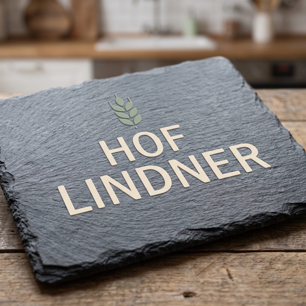 Dark slate board with a matt UV DTF rub-on sticker, cream farm name