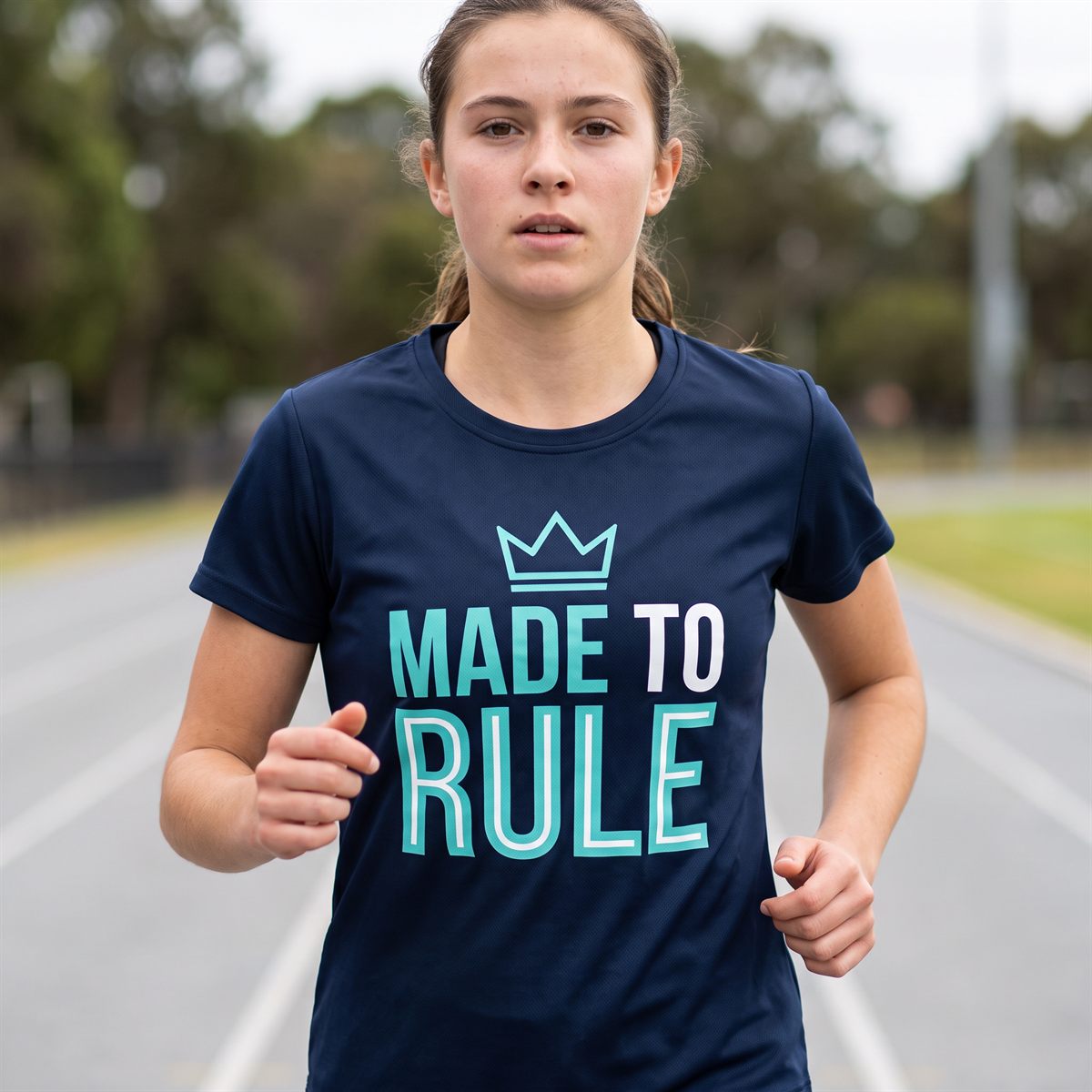 Navy performance shirt printed with Blockout DTF, turquoise lettering with crown
