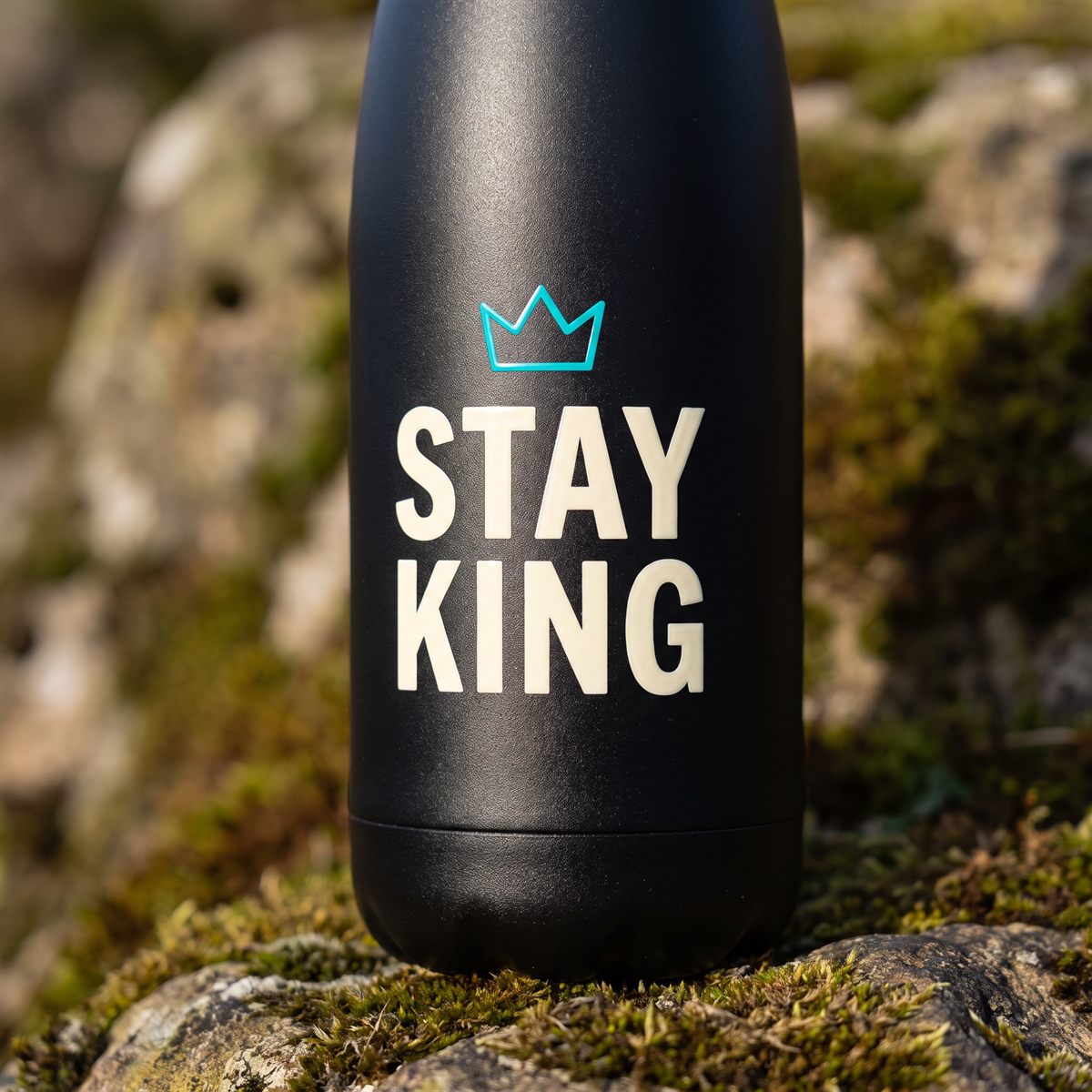 Black metal drinks bottle with a Standard UV DTF rub-on sticker, cream lettering with crown