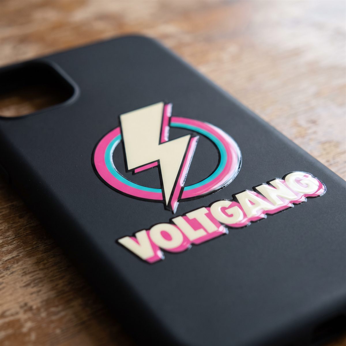 Black phone case with a Standard UV DTF rub-on sticker, multicoloured design with lightning bolt