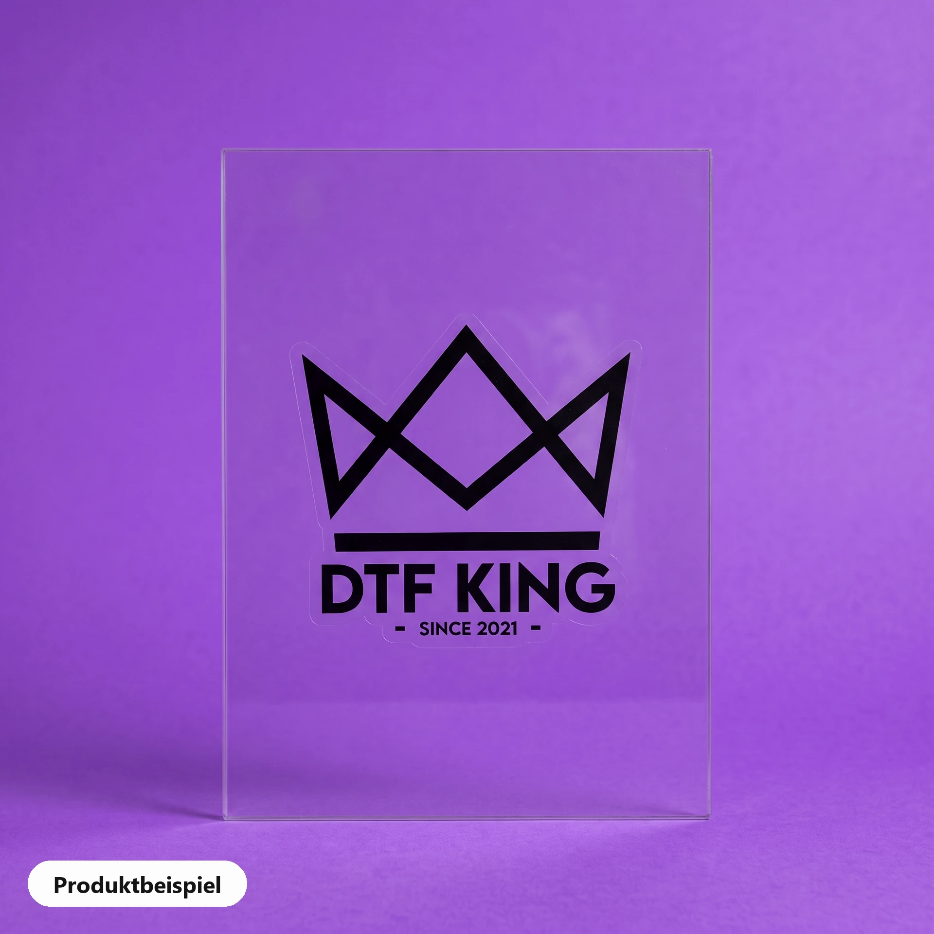 Contour-cut vinyl sticker on clear film, matt laminated, with the DTF KING logo on a pane of glass