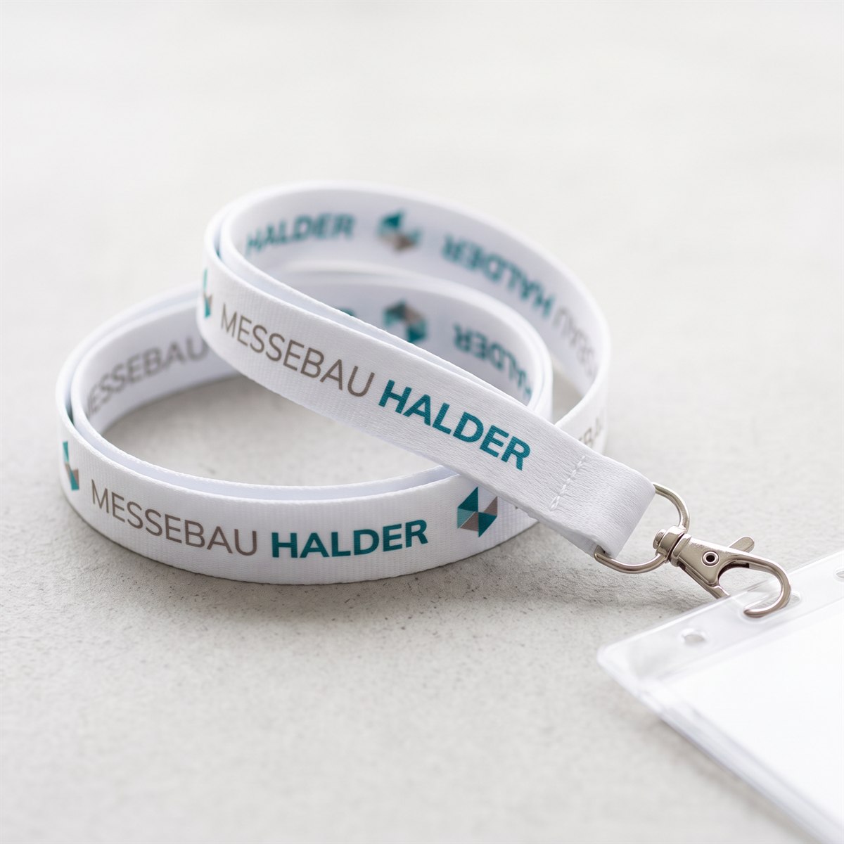 White lanyard with sublimation print, company name repeated along the entire length