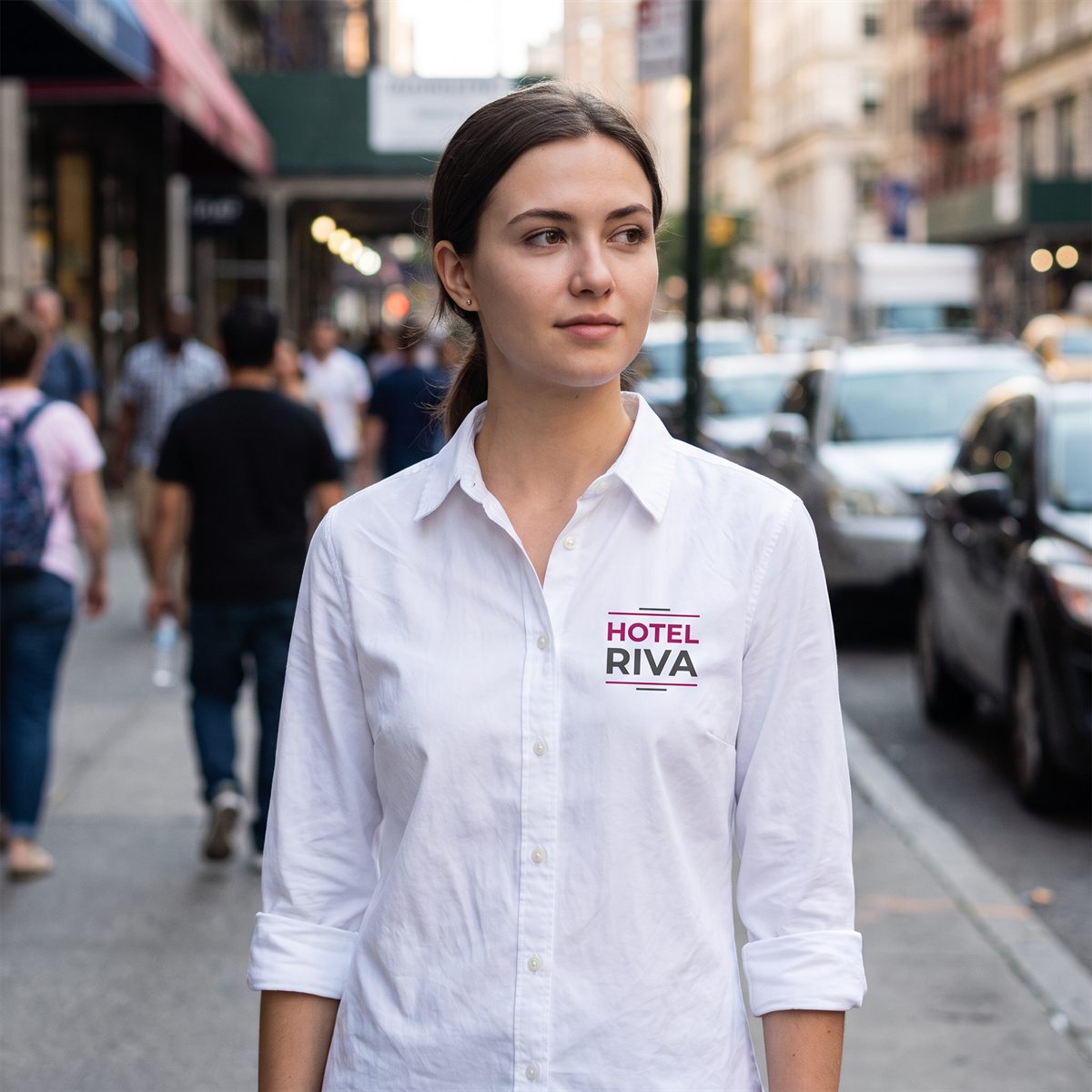White shirt printed with a DTF transfer, company logo in pink and grey on the chest