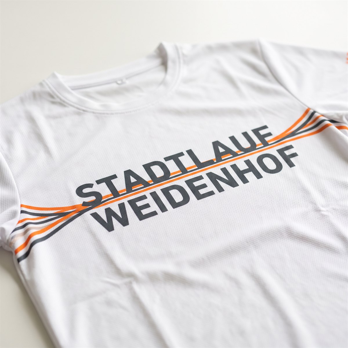 White performance shirt with sublimation print, striped design running over the shoulder